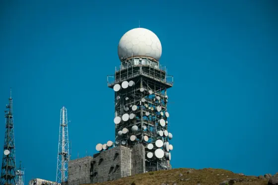 Communications tower with antenna dishes and a spherical radome